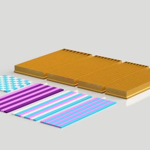 May include: A set of four gold-colored metal trays with a checkered pattern, a purple and white striped pattern, a blue and white striped pattern, and a pink and white striped pattern.