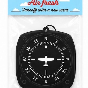 May include: A black air freshener shaped like an aircraft heading indicator in a clear plastic package. The header card features a light blue sky with clouds, the text Aviation Air fresh, and Takeoff with a new scent. The label says Waypoint.