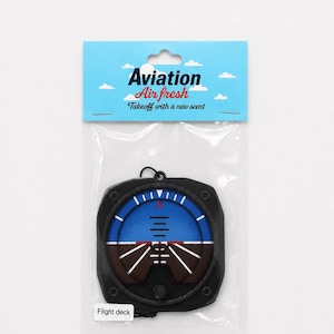 May include: An air freshener shaped like an aircraft attitude indicator in a clear plastic package. The blue and brown gauge graphic is inside a black frame. The header card is light blue with white clouds and text reading Aviation Air fresh Takeoff with a new scent and Flight deck.