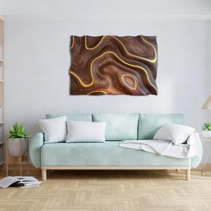 May include: A light blue sofa with white pillows in front of a wall with a brown and gold abstract wall art piece.