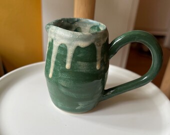 Green handmade small milk jug with white honey drip glaze