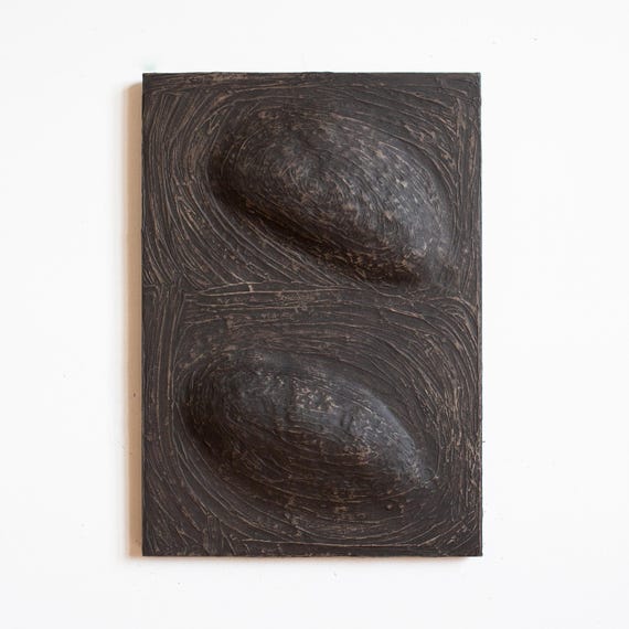Black Wabi Sabi Art. Dimensional wall sculpture made of paper mache and plaster in soft dark color. Organic modern art. Abstract painting.