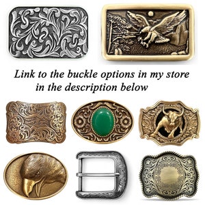 May include: Collection of belt buckles in various designs. Includes a rectangular silver buckle with floral engraving, a gold buckle with an eagle, and a gold buckle with a bull. The text "Link to the buckle options in my store in the description below" is also present.