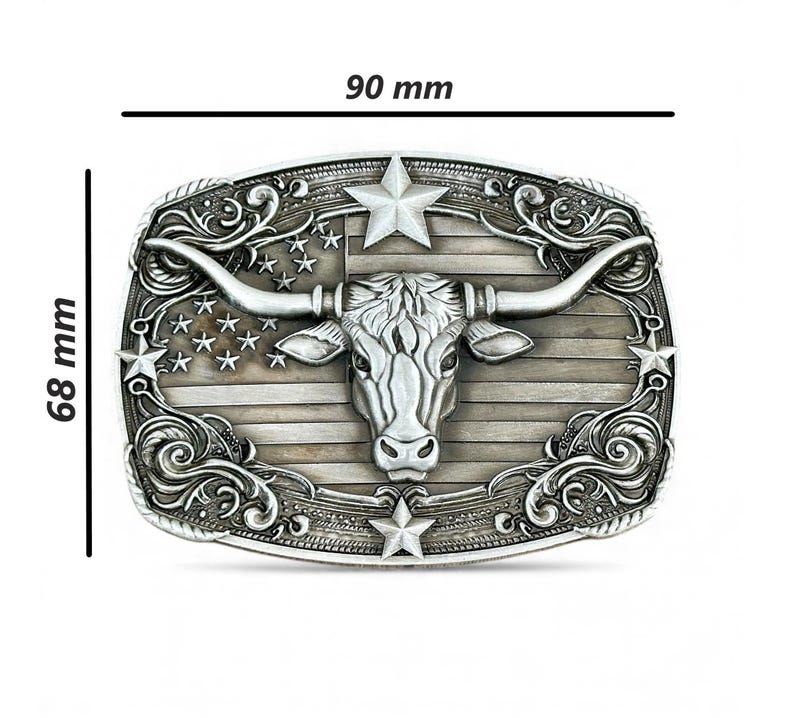 May include: Silver-toned metal belt buckle featuring a longhorn steer head with large horns, set against a backdrop of the American flag. The buckle measures 3.5 inches wide and 2.7 inches high.