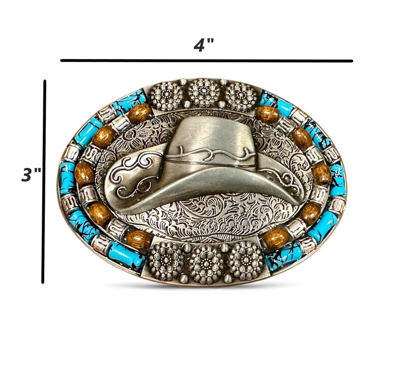 May include: Oval silver-tone belt buckle, 10.16 cm wide and 7.62 cm tall, featuring a cowboy hat design. The buckle is decorated with turquoise and brown beads around the edge, and floral accents.
