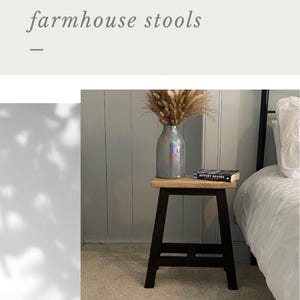 May include: A handmade rustic farmhouse stool with a black frame and a natural wood top. A vase with dried flowers and a book are on the stool. The text "Handmade Rustic farmhouse stools" is visible.