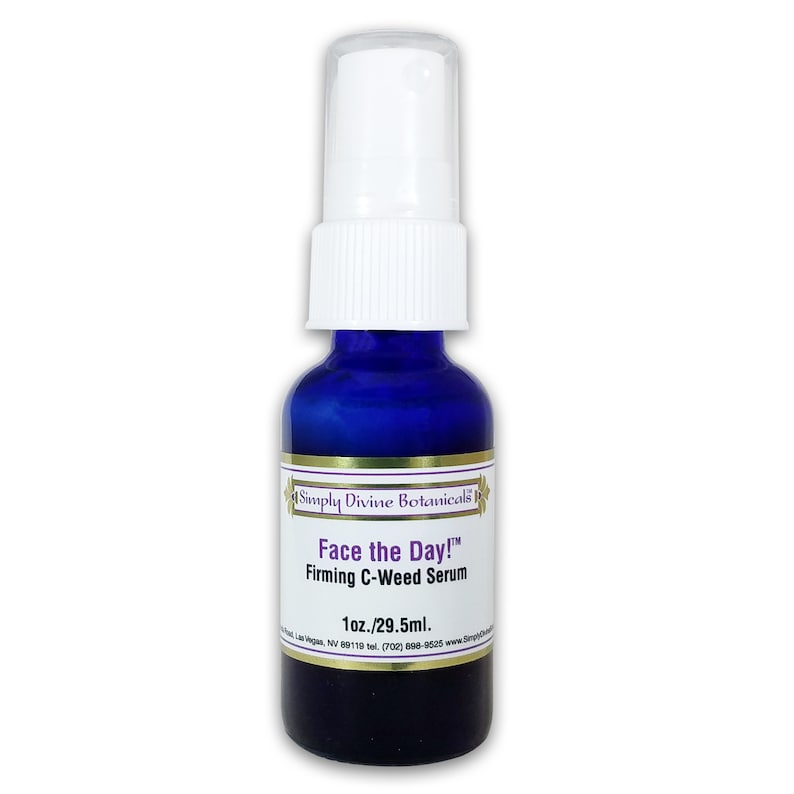 May include: A cobalt blue glass bottle with a white pump dispenser. The label reads "Face the Day! Firming C-Weed Serum" and "1oz./29.5ml." The product is from Simply Divine Botanicals.