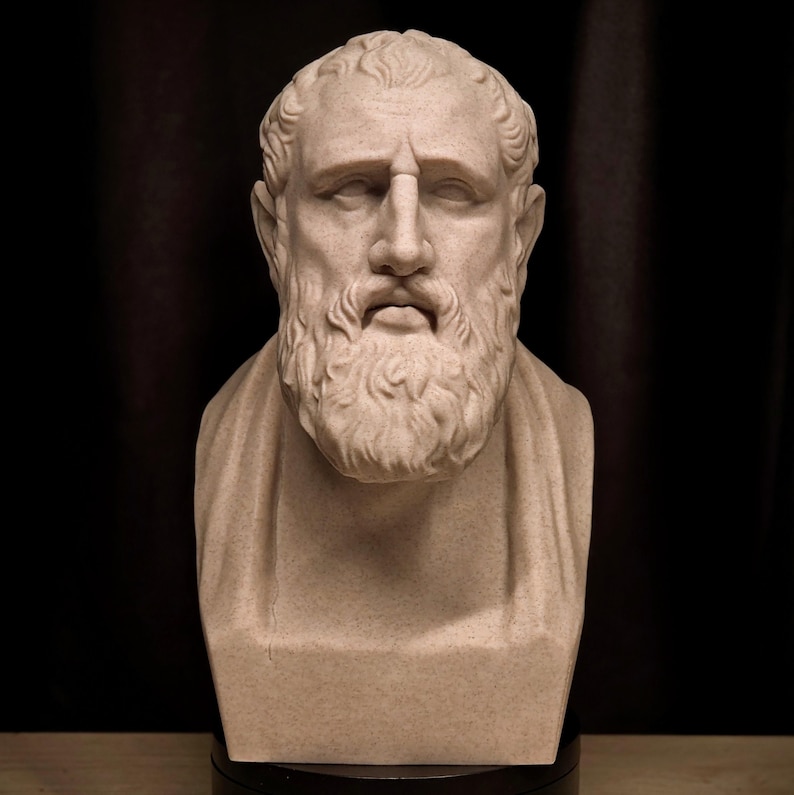 May include: A beige bust of a man with a beard and curly hair. The sculpture has a serious expression and is set against a dark background. The bust is a classical art piece.