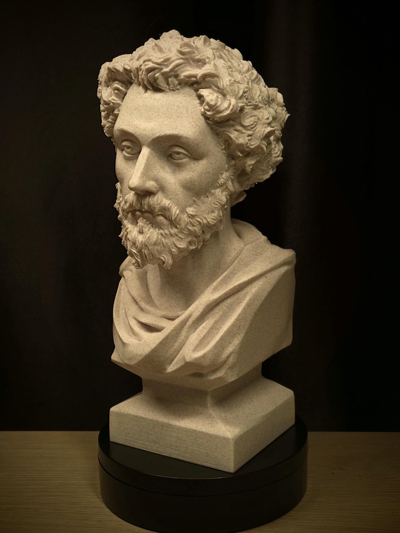 May include: A detailed bust sculpture of a man with curly hair and a beard. The sculpture is a light beige color and is set on a black rotating base. The man is wearing a draped garment.