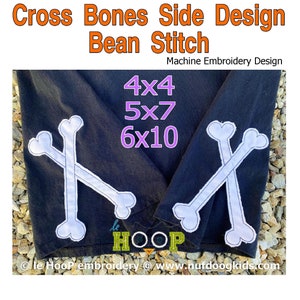 May include: Machine embroidery design for cross bones in 4x4, 5x7, and 6x10 hoop sizes. The design is stitched on a black t-shirt with white thread.