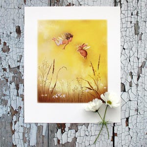 May include: A whimsical art print featuring a fairy and a rabbit with wings, set against a yellow background. The illustration includes wildflowers and grasses, with two white cosmos flowers in the foreground. The artwork is on white paper.