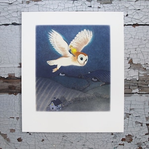 May include: A square art print featuring a barn owl in flight against a dark blue night sky. A small figure with a bright yellow star sits on the owl's back. Below, a landscape shows rolling hills, small houses with glowing windows, and trees.