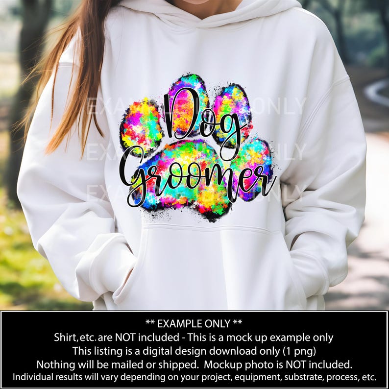 May include: A white hoodie with a colorful paw print design that says "Dog Groomer".