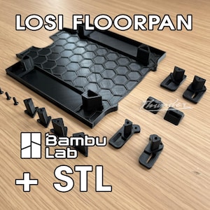 May include: Black 3D-printed LOSI floorpan with a honeycomb pattern, accompanied by various black mounting components and screws. The image includes the text "LOSI FLOORPAN", "Bambu Lab", and "+ STL".