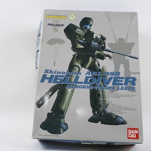 May include: A model kit box featuring a green and black robot with the text "Shinohara ARL-99B HELLDIVER AIRBORNE TROOPS LABOR". The box has a white background with illustrations of parachutes and a silhouette of a robot.