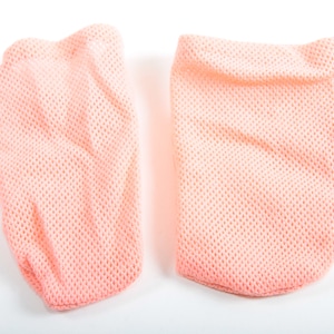 May include: Two peach-colored mesh fabric finger covers. The covers are made of a soft, breathable material and are designed to protect fingers from dirt and grime.