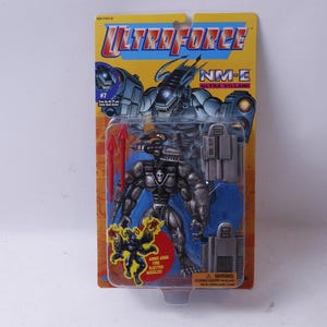 May include: Ultraforce NM-E Ultra Villaine action figure in original packaging. The figure is silver and gray with red accents, and comes with accessories. The packaging is yellow and blue.