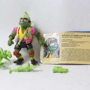 May include: A green Teenage Mutant Ninja Turtles action figure named Sewer-Cyclin' Raph wearing a yellow vest, pink shoulder pads, and black shorts. Accessories include a lime green unicycle, a pump gun, and a water bottle. Includes a character card.