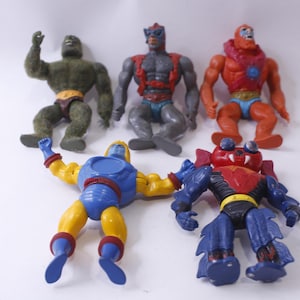 Puede incluir: Cinco figuras de acción vintage, incluyendo una verde, una azul, una roja y dos grises. Las figuras están todas en diferentes poses y tienen varios accesorios.