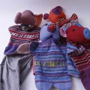May include: Four colorful hand puppets with different animal faces. The puppets are made of fabric and have a striped pattern. The puppets are a blue bear, a red pig, a brown elephant, and an orange bear.