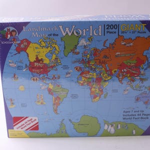 May include: A boxed 200-piece giant puzzle titled "Landmark Map of the World." The puzzle features a colorful world map with continents and countries. The box is 20" x 27" and includes a 44-page world fact book. Ages 7 and up.
