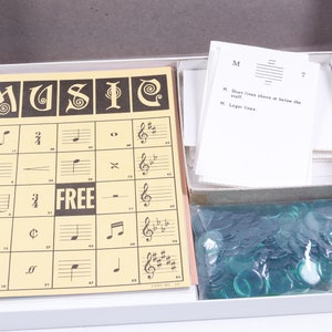 May include: A vintage board game called "MUSIC" with a yellow game board, a set of instructions, and a bag of green game pieces. The game board has a grid with musical notes and symbols.