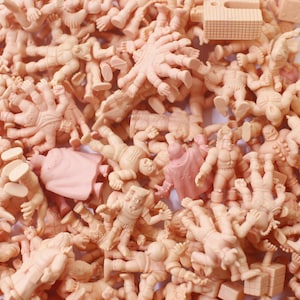 May include: A large collection of small, pink plastic figures. The figures are all in different poses and some have multiple arms or legs.