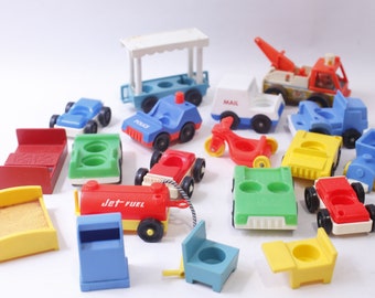 May include: A collection of vintage plastic toy vehicles, including a red fire truck, a blue police car, a yellow school bus, a green car, a red motorcycle, a white mail truck, and a blue and white train. There are also several other toys, including a red bed, a yellow bed, a green chair, a blue mailbox, and a red and yellow gas truck.