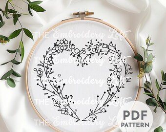 繊細な花柄のハート型リースの手刺繍パターン、ピンクの花が咲いた