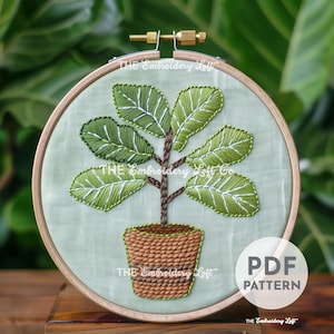 May include: Embroidered pattern of a potted plant with green leaves and a brown pot. The pattern is in a hoop and the text "PDF PATTERN" is visible in the lower right corner.