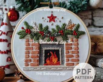 May include: Embroidered hoop art featuring a brick fireplace with a roaring fire and a festive garland of greenery, red berries, and a star on top. The text "THE Embroidery Loft" is visible on the hoop.