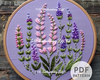 May include: A purple embroidery hoop with a floral design featuring pink and purple flowers and green leaves. The text "THE Embroidery Loft" appears three times on the hoop. The text "PDF PATTERN" appears in the lower right corner of the hoop.