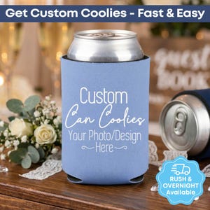 May include: A light blue can cooler with the text "Custom Can Coolies" and "Your Photo/Design Here" in white. A silver can sits inside the cooler. The image also includes text that says "Rush & Overnight Available."