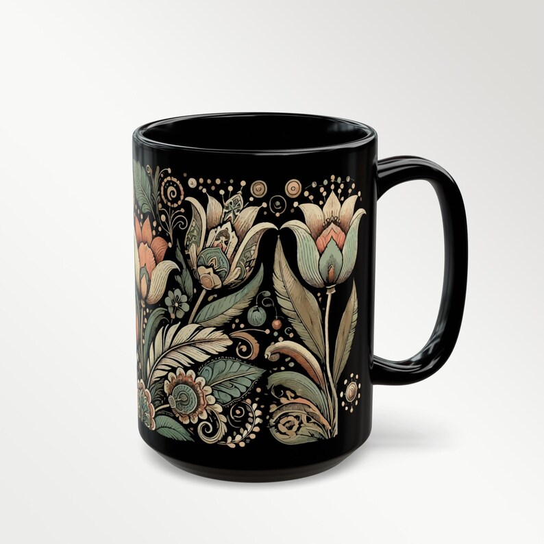 Black ceramic mug featuring a tulip floral design, ideal for tea or coffee enthusiasts. Boho-style artisan coffee cup for bohemian kitchen decor or vintage-inspired gift ideas. A charming addition to your daily routine or a thoughtful present for her