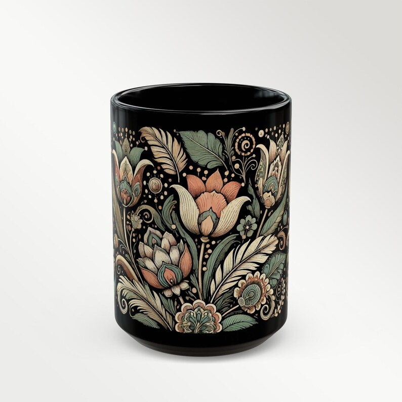 Black ceramic mug featuring a tulip floral design, ideal for tea or coffee enthusiasts. Boho-style artisan coffee cup for bohemian kitchen decor or vintage-inspired gift ideas. A charming addition to your daily routine or a thoughtful present for her