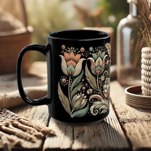 Boho black ceramic coffee mug with tulip floral design, perfect for tea or coffee lovers. Artisan drinkware for vintage-inspired kitchens or bohemian decor. Makes a unique gift for her or a decorative piece for retro and artistic home settings.