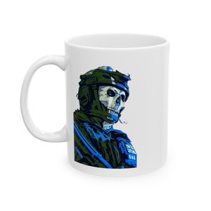 May include: White ceramic mug featuring a detailed illustration of a skull-faced soldier in a green helmet and blue tactical gear. The design includes the text "SAS" and a British flag patch. The mug has a curved handle.