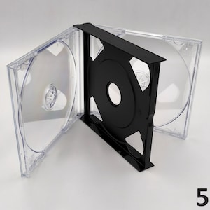 May include: Clear plastic CD jewel case with a black tray, open to display the interior. The case is on a white surface. The number "5x" is in the bottom right corner.