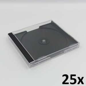 May include: A clear, transparent plastic CD case with a black interior and a black spine. The number "25x" is printed in black on the bottom right corner of the image. The case is designed to hold a single CD.