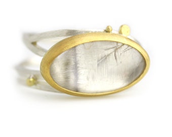 Silver Rutile Oval and Gold Dots on a Swirled Band. Size 8 1/2.