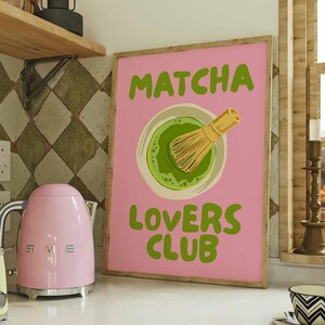 Pink matcha printable wall art featuring Matcha Lovers Club typography with a green matcha bowl and bamboo whisk on a bright pink background, ideal for matcha wall art, matcha print, tea lover gift, kitchen wall art, kitchen print, coffee bar decor, pink wall art, green wall art, cute wall art, girly wall art, dopamine decor and apartment decor.