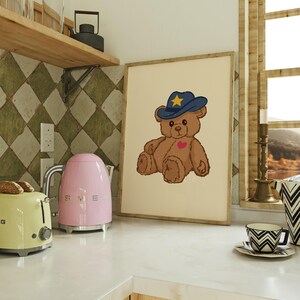 Retro teddy bear cowboy print for nursery or dorm decor, perfect for vintage wall art lovers, Western art themes, and playful apartment wall decor. Printable wall art featuring a cute bear with a cowboy hat.