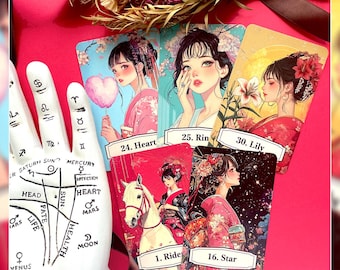 May include: A set of tarot cards featuring illustrations of women in traditional Japanese attire. The cards are numbered and labeled with titles like "Heart," "Rin," and "Lily." A white hand with palmistry markings is in the foreground.