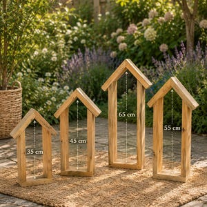 May include: Four light brown wooden house-shaped frames with open centers. The frames have heights of 35 cm, 45 cm, 65 cm, and 55 cm respectively, as indicated by the white dashed arrows and text labels printed on each individual wooden structure.