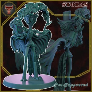 May include: A teal-colored figurine of a character with flowing hair and a cape, holding a book. The figure is on a round base, with the word "STOLAS" at the top. The words "Pre-Supported" are at the bottom.