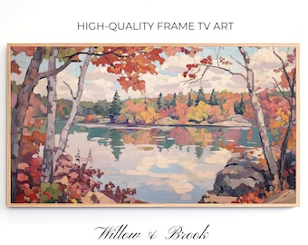 May include: A framed painting of a lake scene with fall foliage in shades of red, orange, yellow, and green. The lake is reflecting the colors of the trees and the sky. The text "Willow & Brook" is written in cursive at the bottom of the painting.