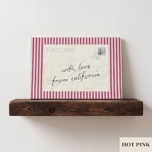 May include: A rectangular postcard print featuring a cream-colored background with the text POST CARD and the handwritten script with love from california. The design is framed by a border of vertical hot pink and white stripes.