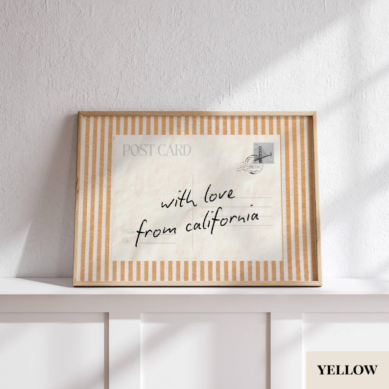 May include: A rectangular framed print featuring a vintage postcard design with vertical orange and white stripes. The postcard includes the text POST CARD, a stamp graphic, and the handwritten script with love from california in black ink.