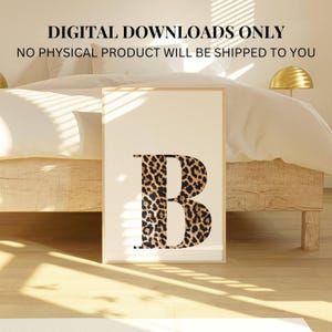 May include: A framed print featuring the letter "B" in a bold, modern design. The letter is partially filled with a leopard print pattern in shades of brown and black. The background is a soft cream color, and the text "DIGITAL DOWNLOADS ONLY" is at the top.