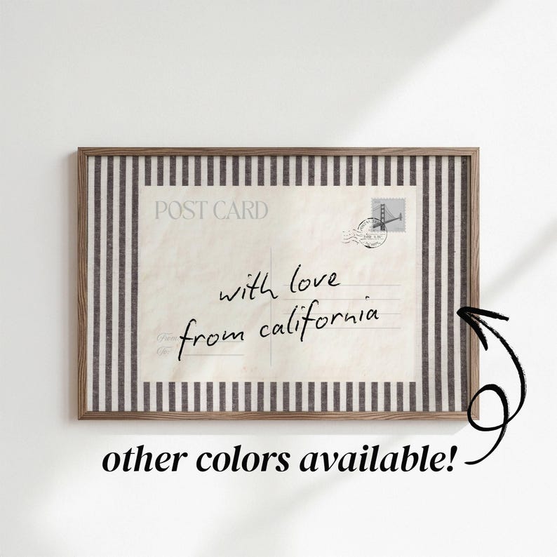 May include: A rectangular framed print featuring a vintage postcard design with the text "POST CARD" and "with love from california" in black script. The postcard is centered against a background of vertical black and white stripes.